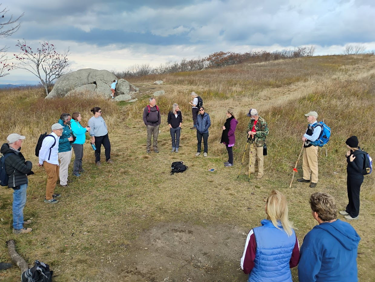 A group of hikers standing in a circle.